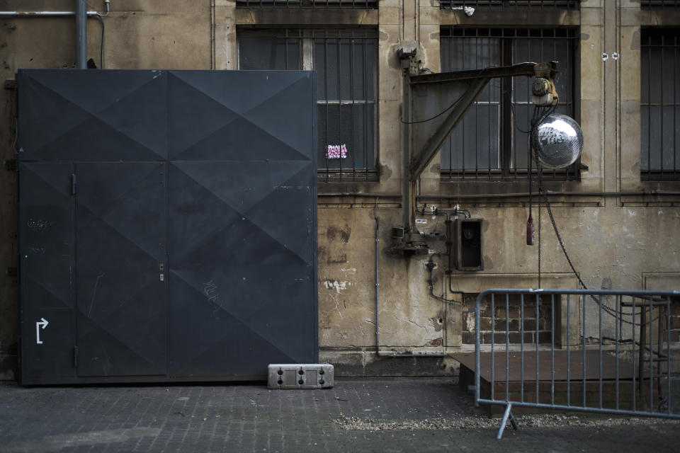 In this March 25, 2020, photo, an entrance to music club Alte Muenze is locked in Berlin, Germany. The nightclubs in the German capital have decided to keep the beat going — at least online. Berlin's nightclubs were closed on March 13 in an attempt to slow the spread of the coronavirus. In response, some clubs formed a streaming platform to let DJs, musicians and artists continue to perform. (AP Photo/Markus Schreiber)