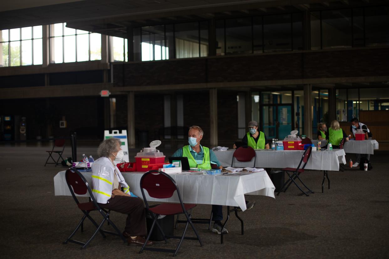 Nurses and volunteers from the Oakland County Health Department wait for patients to receive their coronavirus (COVID-19) vaccine on Aug. 24, 2021, at the Southfield Pavilion in Southfield, Mich. Oakland County is the second county in Michigan to reach the state's goal of vaccinating 70% of its population.