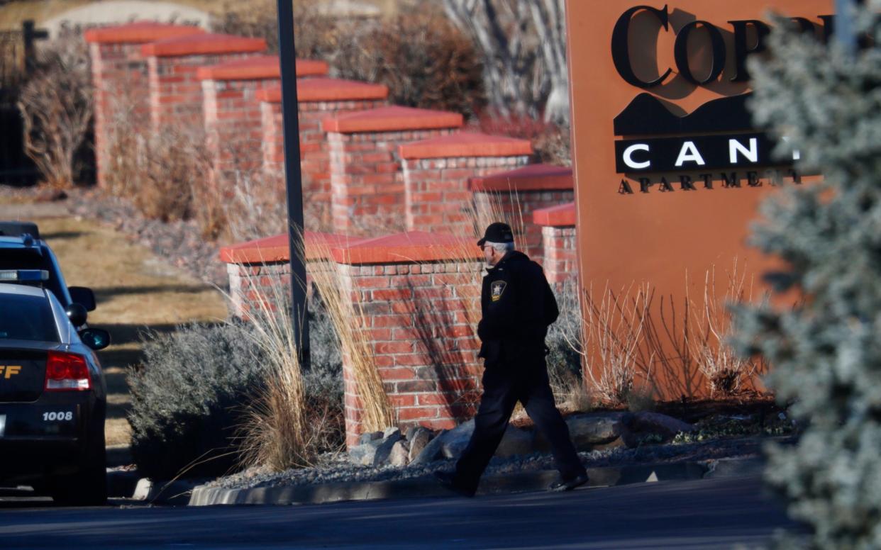 An investigator heads to the scene of a shooting that claimed the life of a sheriff's deputy in Highlands Ranch, Colorado - AP