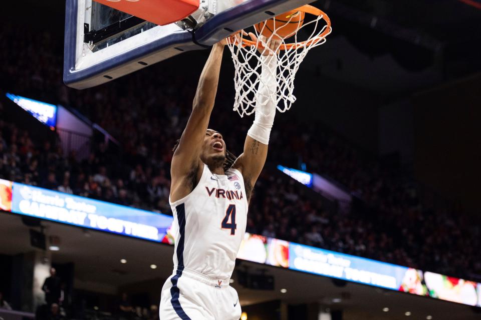 Virginia's Armaan Franklin (4) dunks the ball against Notre Dame during the second half of an NCAA college basketball game in Charlottesville, Va., Saturday, Feb. 18, 2023. (AP Photo/Mike Kropf)