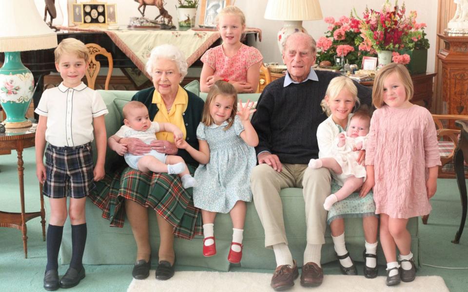 Released shortly after his death, this picture shows Prince Philip with seven of his great-grandchildren. Savannah Philips is standing at the back, while her sister Isla is seen holding her cousin Lena Tindall - AFP