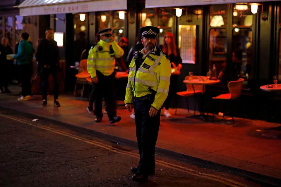 Police patrol in Soho, in central London on September 24, 2020, on the first day of the new earlier closing times for pubs and bars in England and Wales, introduced to combat the spread of the coronavirus. - Britain has tightened restrictions to stem a surge of coronavirus cases, ordering pubs to close early and advising people to go back to working from home to prevent a second national lockdown. (Photo by Tolga Akmen / AFP) (Photo by TOLGA AKMEN/AFP via Getty Images)