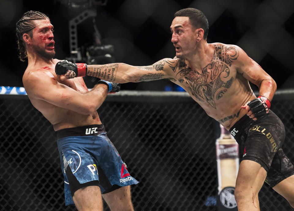 Max Holloway, right, fights Brian Ortega during the UFC Featherweight championship title bout in Toronto on Sunday, Dec. 9, 2018. Holloway won the title fight. (Nathan Denette/The Canadian Press via AP)