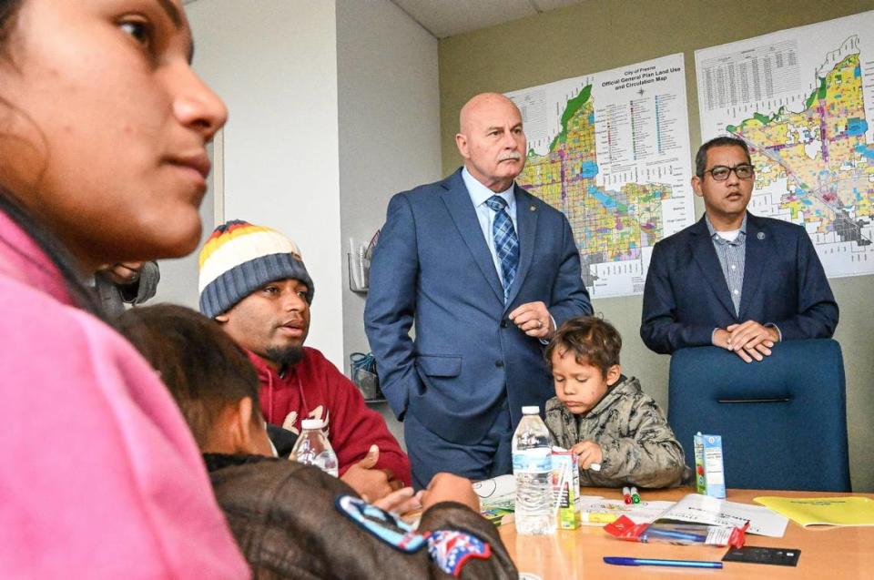 Fresno Mayor Jerry Dyer, center and City Councilmember Miguel Arias meet with asylum-seeking migrant families and individuals at Fresno City Hall on Friday, Feb. 2, 2024. The migrants are among a group from Venezuela and Peru who were sent by bus from Texas to Denver, and then on to Fresno, arriving the previous weekend.