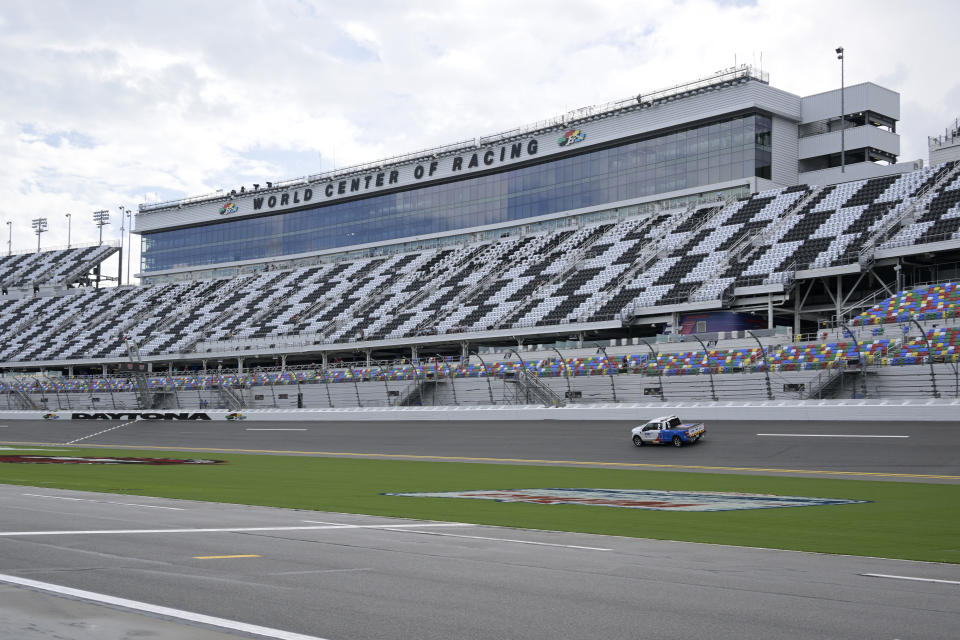 Track officials drive through the front stretch after rain forced cancellations of qualifying for a NASCAR Xfinity and Cup Series auto races at Daytona International Speedway, Friday, Aug. 26, 2022, in Daytona Beach, Fla. (AP Photo/Phelan M. Ebenhack)