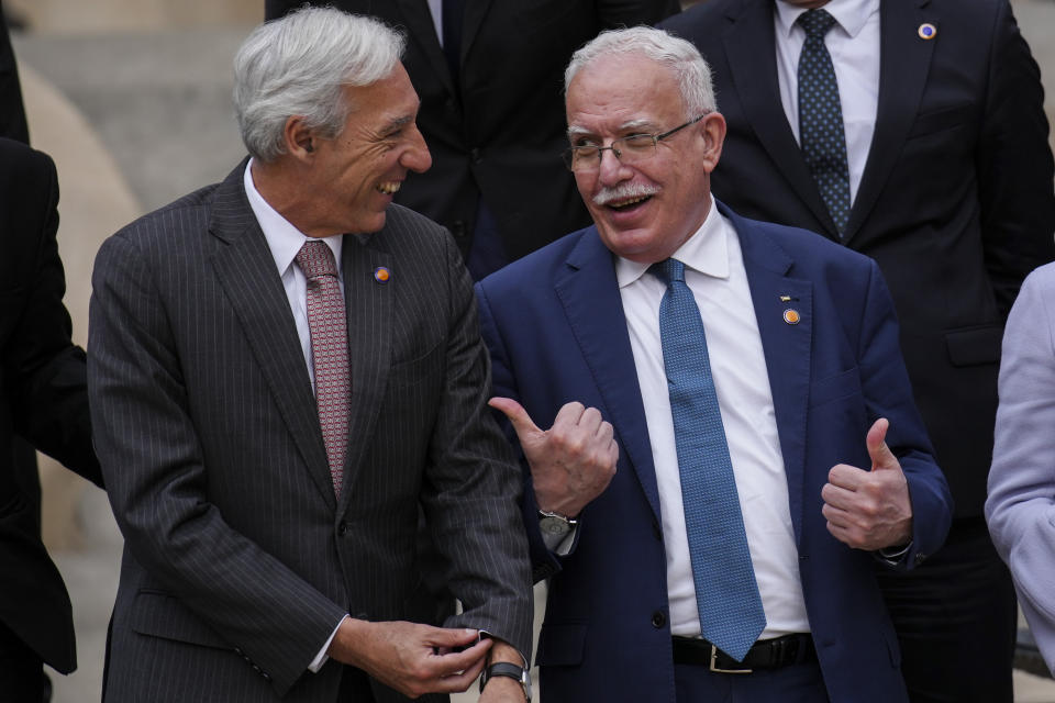 Palestinian Foreign Minister Riad al-Malki, right, talks with Portugal's Foreign Minister Joao Gomes Cravinho prior to a family picture with members of European Union member states, Middle East and northern Africa countries at the Union for the Mediterranean event in Barcelona, Spain, Monday, Nov. 27, 2023. (AP Photo/Emilio Morenatti)