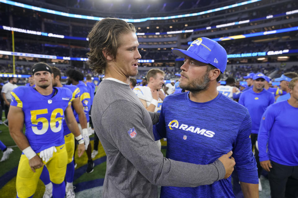 Los Angeles Chargers quarterback Justin Herbert, left, hugs Los Angeles Rams quarterback Matthew Stafford after a preseason NFL football game Saturday, Aug. 12, 2023, in Inglewood, Calif. (AP Photo/Mark J. Terrill)