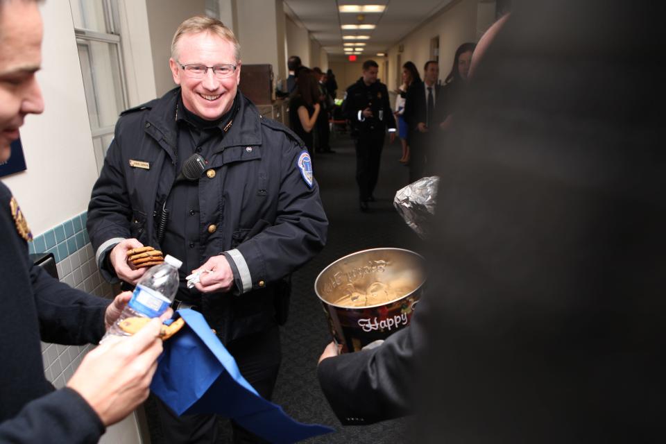 Howard Liebengood, a Capitol Police officer since 2005, receives cookies from Sen. Chris Coons on Dec. 11, 2014 to mark the holidays. Liebengood died while off-duty Saturday, days after supporters of President Donald Trump stormed the Capitol building.