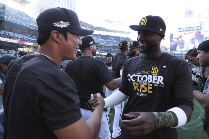 San Diego Padres' Jurickson Profar, right, celebrates with Ha-Seong Kim following a baseball game against the Chicago White Sox after clinching a wild-card playoff spot, Sunday, Oct. 2, 2022, in San Diego. (AP Photo/Derrick Tuskan)
