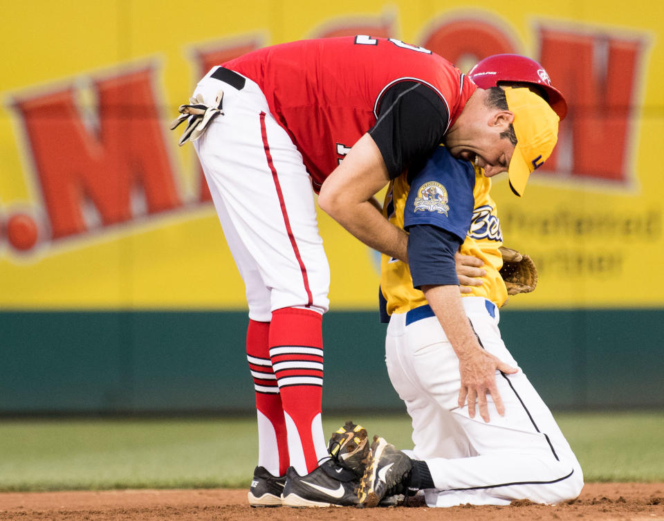 <p>Democrats’ shortstop Rep. Tim Ryan, D-Ohio, gives Rep. Jack Bergman, R-Mich., a hug after a play at second base during the annual Congressional Baseball Game at Nationals Park in Washington on Thursday, June 15, 2017. (Photo: Bill Clark/CQ Roll Call/Getty Images) </p>