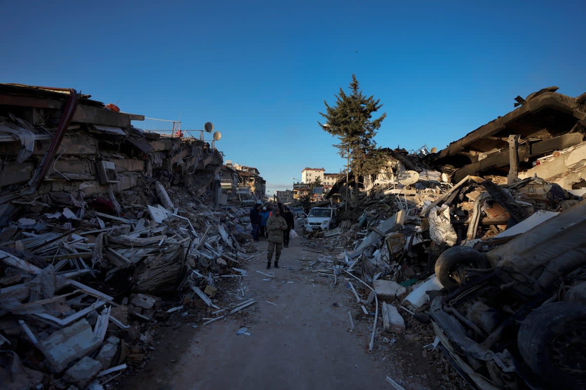 A man walks amid destroyed buildings in Antakya, southern Turkey (Copyright 2023 The Associated Press. All rights reserved.)