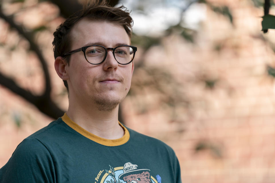 Noah Burden, 28, poses for a portrait outside his apartment complex, Wednesday, Aug. 23, 2023, in Alexandria, Va. Burden, a communications consultant in Alexandria, thinks Joe Biden and Donald Trump are both too old to be president. He says leaders in their 70s or 80s stand for "a sense of values and sense of the country and the world that just isn’t accurate anymore.” In a new AP-NORC poll, 77% say Biden is too old to be effective in a second term. Fewer worry about Trump’s age but voters have other problems with him. (AP Photo/Stephanie Scarbrough)