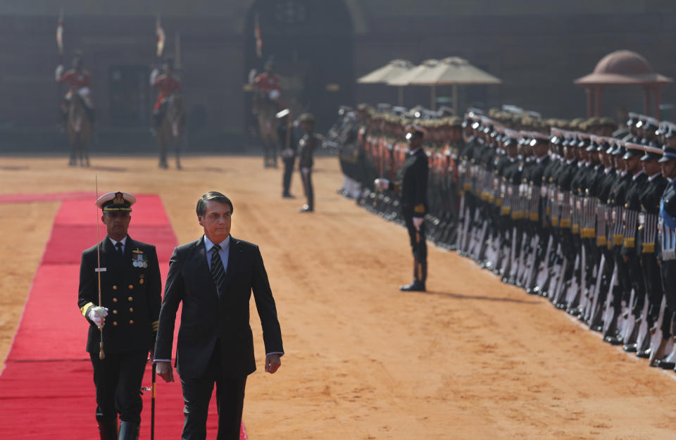 Brazil's President Jair Bolsonaro inspects a joint military guard of honor during his ceremonial reception at the Indian presidential palace in New Delhi, India, Saturday, Jan. 25, 2020. Bolsonaro is this year's chief guest for India's Republic day parade. (AP Photo/Manish Swarup)