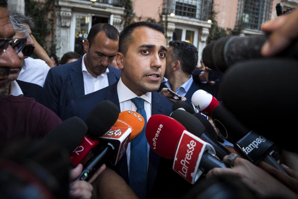 Leader of Five-Star Movement, Luigi Di Maio, center, talks with journalists as he walks outside the Lower Chamber in Rome, Friday, Aug. 23, 2019. Italian President Sergio Mattarella says he has agreed to political leaders' request for more time to see if a viable government can be formed to replace the one that collapsed this week. (Angelo Carconi/ANSA Via AP)