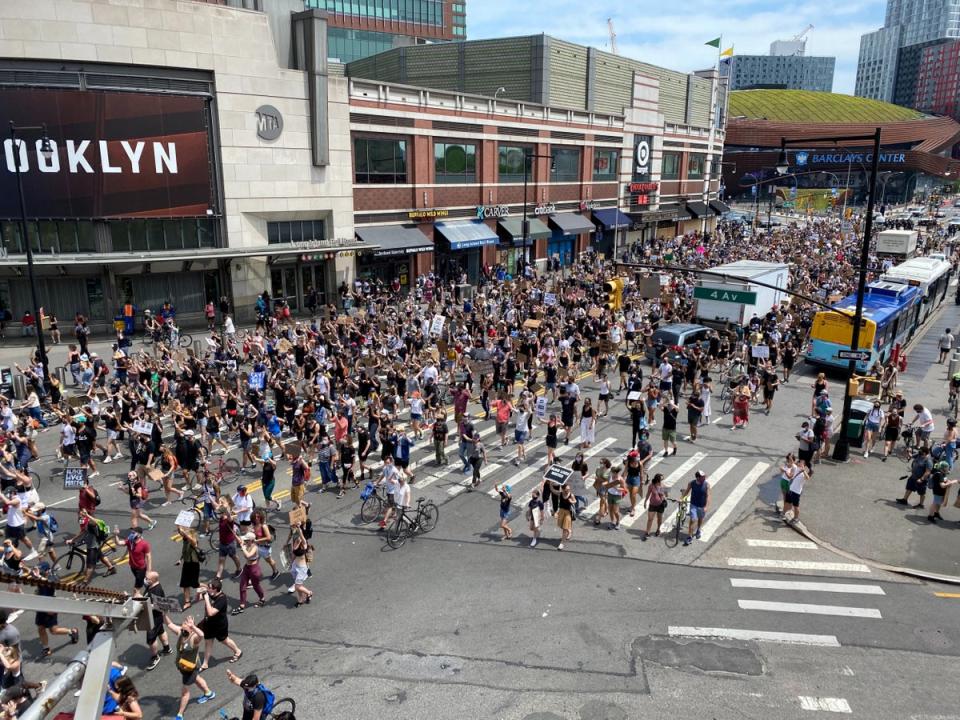 Demonstrators march down Flatbush Avenue toward the Manhattan Bridge chanting slogans (REUTERS)