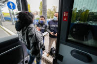 Carabinieri policemen check the green health pass of public transportation passengers in Rome, Monday, Dec. 6, 2021, on the first day a super green health pass went into effect. Italian police can check whether diners in restaurants or bars have a "super" green health pass certifying that they are either vaccinated or have recently recovered from the virus. (AP Photo/Andrew Medichini)