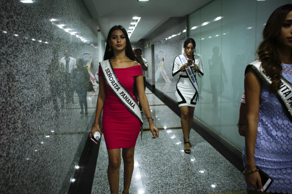 In this Sept. 12, 2018, Miss Panama, Rosa Iveth Montezuma, left, leaves a visit to the Tourism Ministry in Panama City. Montezuma, is the first indigenous woman to win the "Miss Panama" beauty pageant. (AP Photo/Arnulfo Franco)