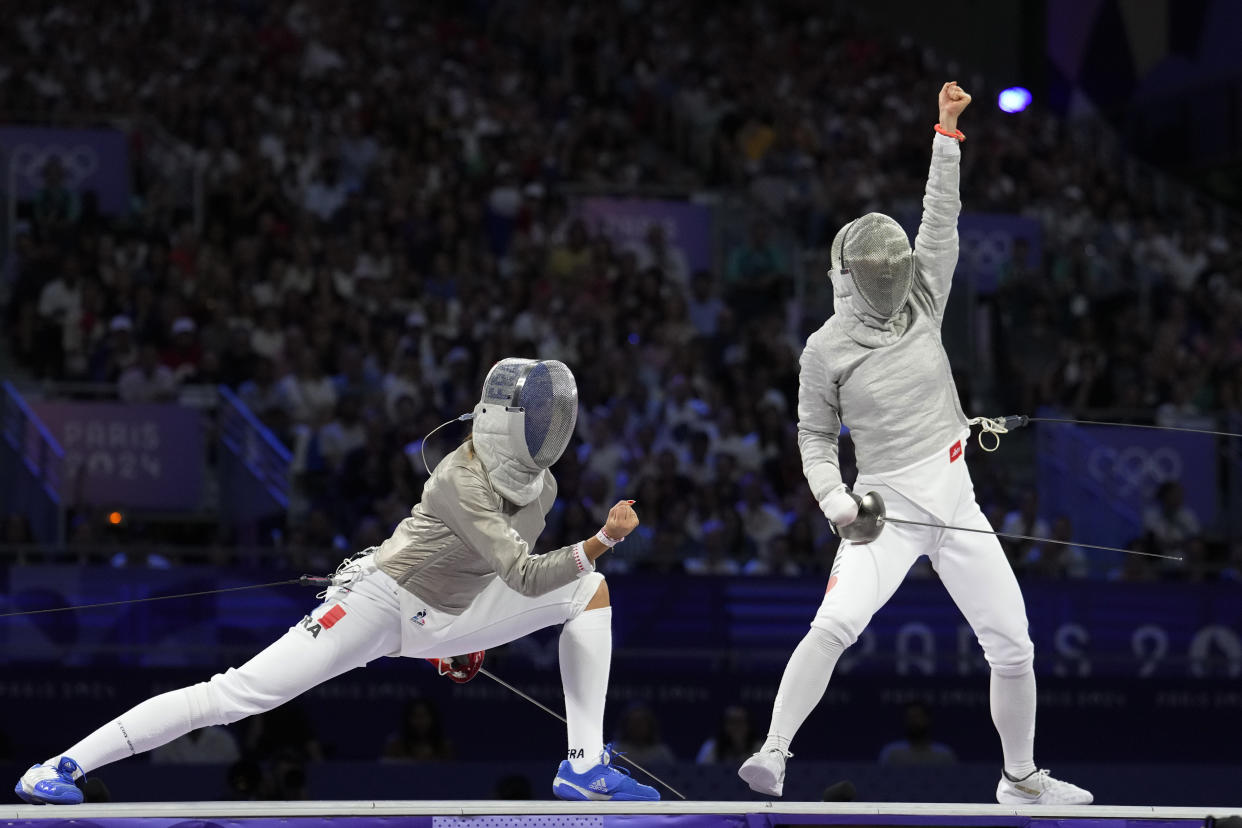 JJapan's Misaki Emura, right, reacts as she competes with France's Sara Balzer in the women's team saber bronze final match at the Paris Olympics on Saturday. 