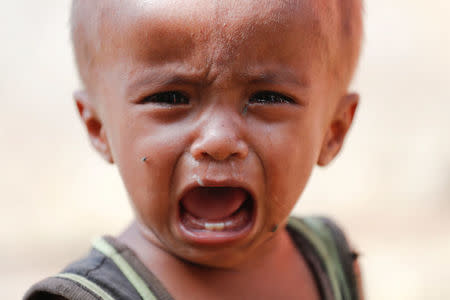 A Rohingya refugee child cries at the camp for widows and orphans inside the Balukhali camp near Cox's Bazar, Bangladesh December 5, 2017. More than 230 women and children live at a so-called widows camp built by fellow refugees with the help of donor funds for Rohingya widows and orphans to offer them better protection and shelter. REUTERS/Damir Sagolj