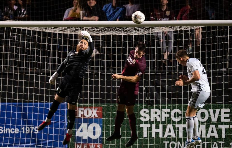 Sacramento Republic goalkeeper Danny Vitiello, left, gets his hand on a corner kick to prevent a header from San Jose defender Oskar Agren in a 2-0 win over the Earthquakes on Wednesday, May 25, 2022.