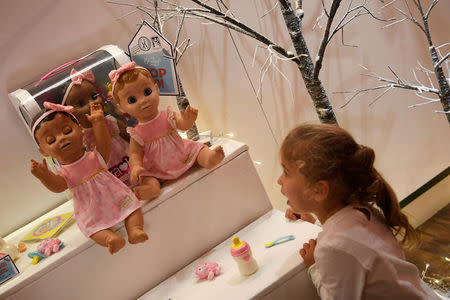 Three year old Harriet reacts as she views a Luvabella Doll which forms part of the selection of predicted top sellers this Christmas at the Hamleys toy store in London, Britain, October 12, 2017. REUTERS/Toby Melville