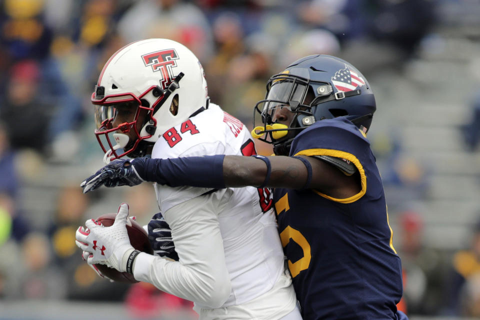 Texas Tech's Erik Ezukanma (84) catches a ball as West Virginia's Kerry Martin Jr. (15) defends during the third quarter of their NCAA college football game in Morgantown, W.Va., Saturday, Nov. 9, 2019. (AP Photo/Chris Jackson)