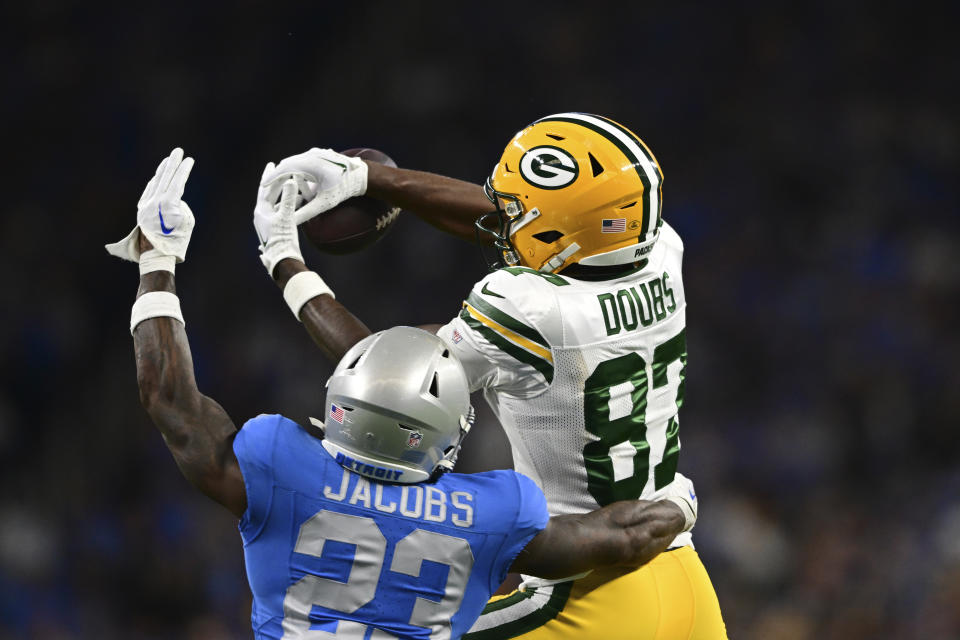 Detroit Lions cornerback Jerry Jacobs (23) helps deflect a pass intended by Green Bay Packers wide receiver Romeo Doubs (87) during the second half of an NFL football game, Thursday, Nov. 23, 2023, in Detroit. (AP Photo/David Dermer)