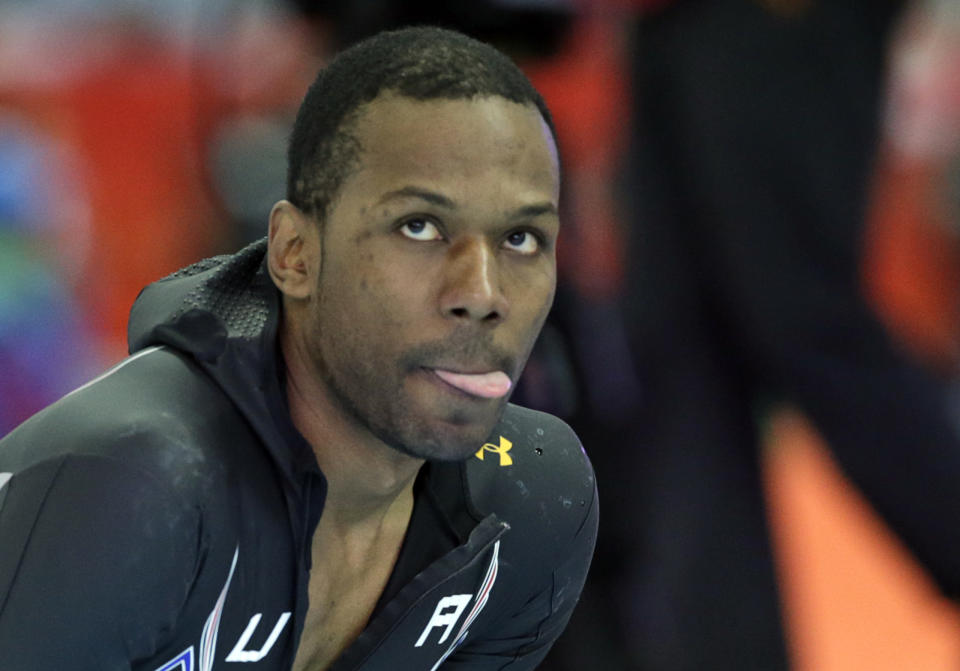 Shani Davis of the U.S. looks up at the screen to see his performance timing after the second heat of the men's 500-meter speedskating race at the Adler Arena Skating Center during the 2014 Winter Olympics, Monday, Feb. 10, 2014, in Sochi, Russia. (AP Photo/Matt Dunham)