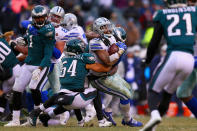 <p>Running back Ezekiel Elliott #21 of the Dallas Cowboys runs for a first down against linebacker Dannell Ellerbe #57 and outside linebacker Kamu Grugier-Hill #54 of the Philadelphia Eagles during the fourth quarter of the game at Lincoln Financial Field on December 31, 2017 in Philadelphia, Pennsylvania. (Photo by Mitchell Leff/Getty Images) </p>