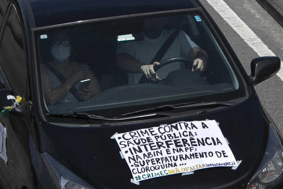 Demonstrators join a caravan in protest against the government's response in combating COVID-19 and demanding the impeachment of Brazil's President Jair Bolsonaro, in Rio de Janeiro, Brazil, Sunday, Jan. 24, 2021. (AP Photo/Bruna Prado)