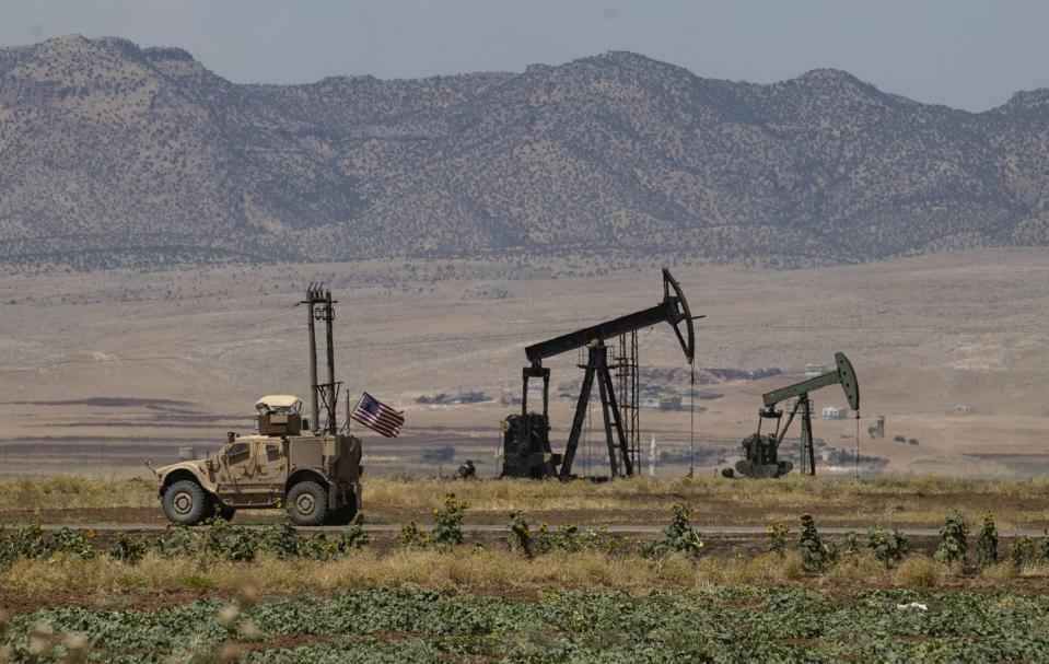 a us armoured vehicle drives past an oil field in the countryside of al qahtaniyah town in syrias northeastern hasakeh province near the turkish border, on august 4, 2020 photo by delil souleiman  afp photo by delil souleimanafp via getty images