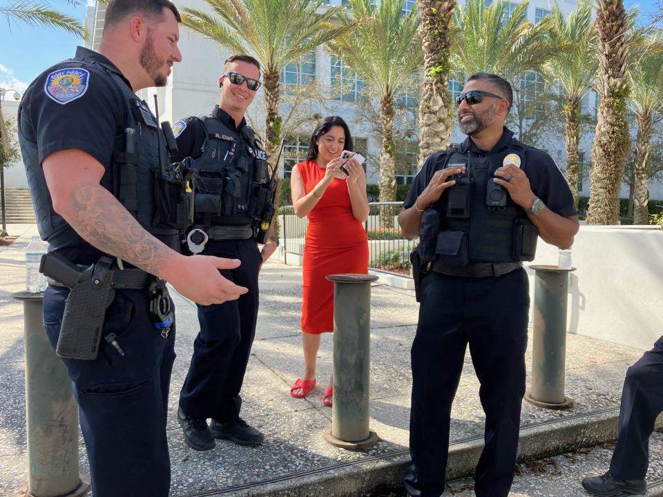 Fort Pierce police officers outside federal courthouse, waiting for word that former President Trump will exit the building.