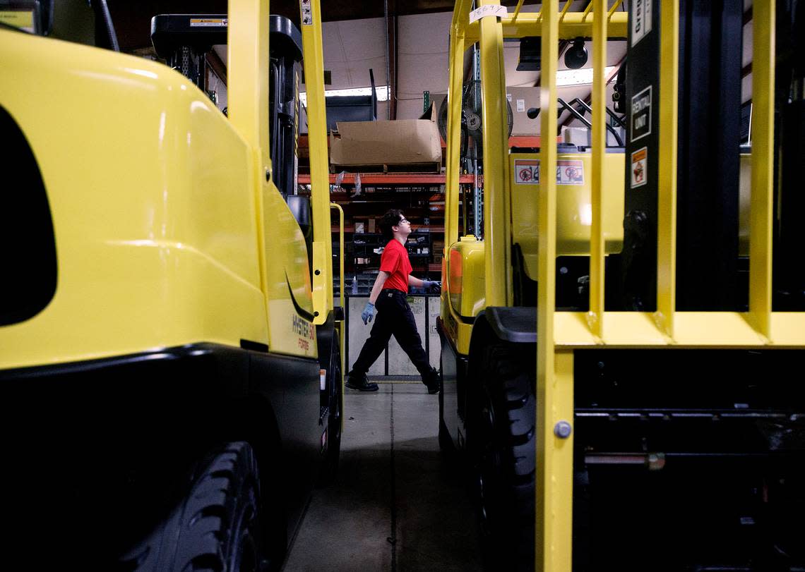 Wake Technical Community College student Dominic Cavallini walks by machinery while working in the shop at The Gregory Poole Equipment Company in Raleigh, N.C. on Thursday, July 18, 2024. Cavallini spends three days per week working at Gregory Poole through Wake Tech’s apprenticeship program. 