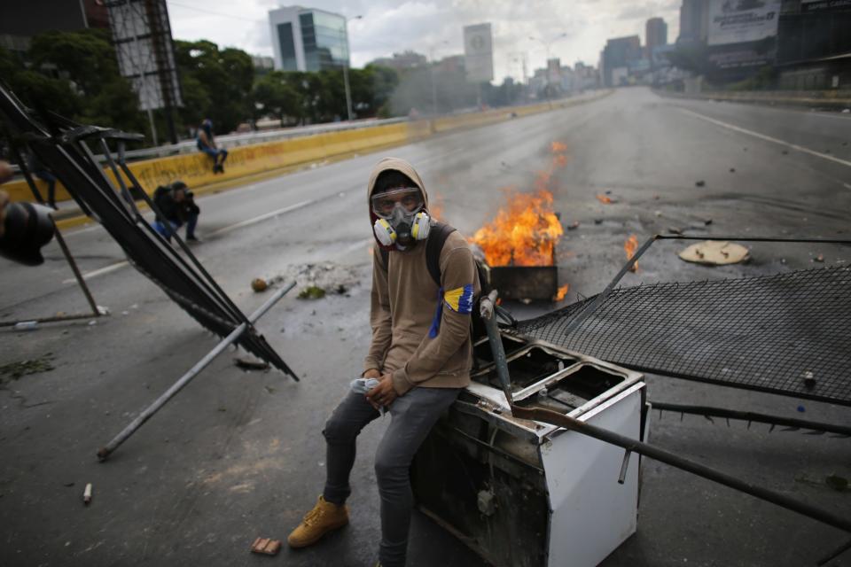 <p>A demonstrator sits on a discarded stove at a barricade, during a national sit-in against President Nicolas Maduro, in Caracas, Venezuela, Monday, May 15, 2017. (AP Photo/Ariana Cubillos) </p>