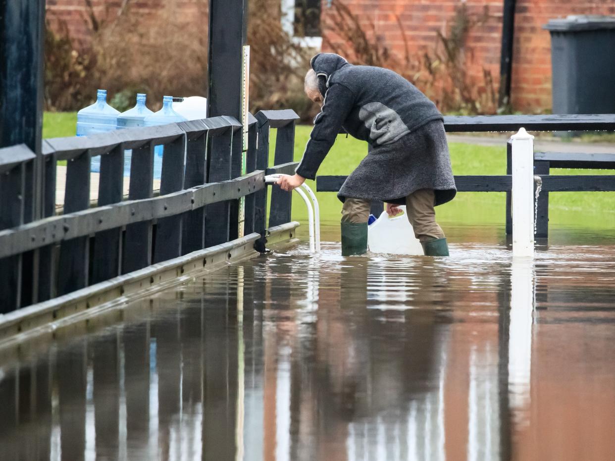 A man in flood water near Naburn Lock Caravan Park in York as Storm Christoph is set to bring widespread flooding, gales and snow to parts of the UK (PA)