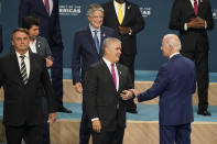 President Joe Biden, right, speaks with Colombian President Ivan Duque as they participate in a family photo with heads of delegations at the Summit of the Americas, Friday, June 10, 2022, in Los Angeles. (AP Photo/Marcio Jose Sanchez)