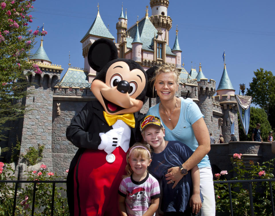 Actress Alison Sweeney and her children Benjamin, 7, and Megan, 3, pose with Mickey Mouse outside Sleeping Beauty Castle at Disneyland park August 31, 2012 in Anaheim, California.  (Photo by Paul Hiffmeyer/Disney Parks via Getty Images)