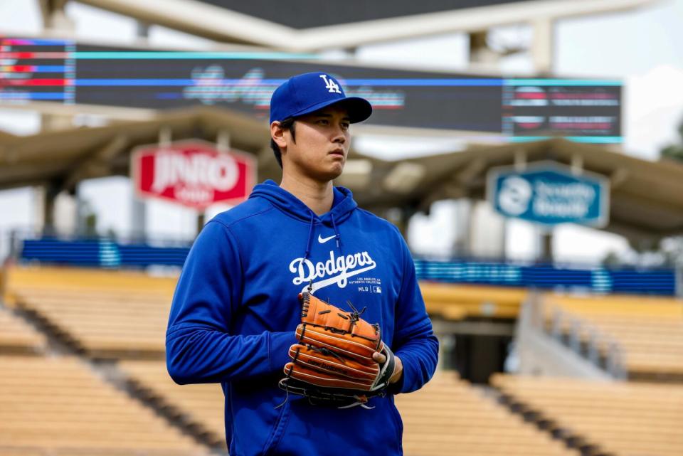 Shohei Ohtani warms up on the field before the Dodgers take on the Angels at Dodger Stadium on Monday.