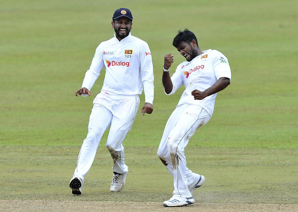 Sri Lanka's Ramesh Mendis, right, celebrates with teammate Dimuth Karunaratne the dismissal of Bangladesh's Najmul Hossain during the third day of the second cricket test match between Sri Lanka and Bangladesh in Pallekele, Sri Lanka, Sunday, May 01, 2021. ( AP Photo/Sameera Peiris)