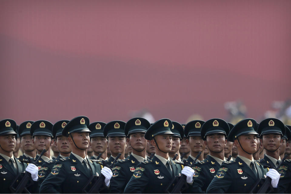 Members of China's People's Liberation Army (PLA) Rocket Force march in formation during a parade to commemorate the 70th anniversary of the founding of Communist China in Beijing, Tuesday, Oct. 1, 2019. Trucks carrying weapons including a nuclear-armed missile designed to evade U.S. defenses rumbled through Beijing as the Communist Party celebrated its 70th anniversary in power with a parade Tuesday that showcased China's ambition as a rising global force. (AP Photo/Mark Schiefelbein)