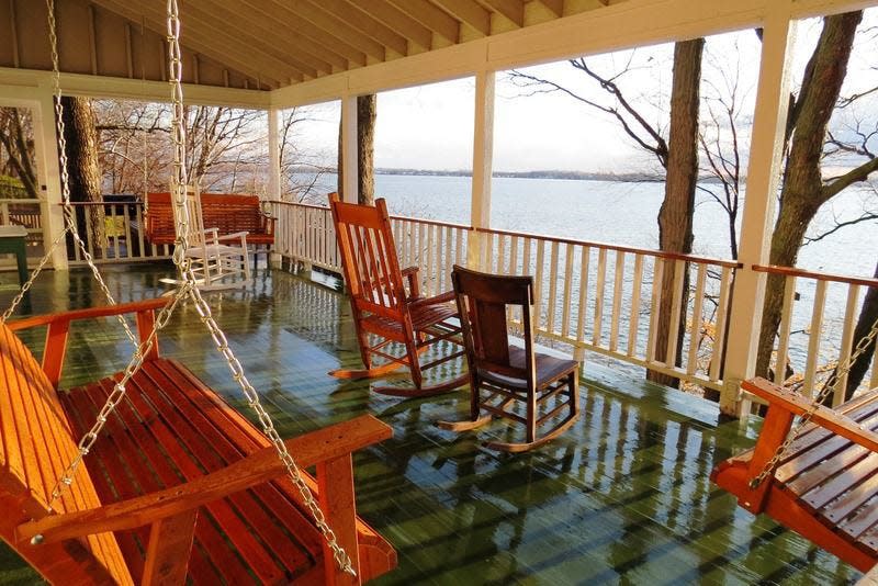 A large west-facing covered porch on the front of the cottage provides a panoramic view of the lake and the historic Culver Academies on its northern shore. Photo by Lee Sandweiss