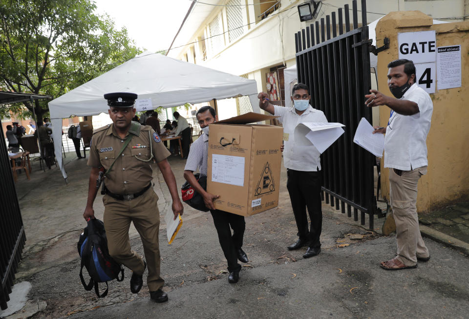 Sri Lankan polling officers carry election material as they dispatch them to polling centers ahead of the parliamentary elections in Colombo, Sri Lanka, Tuesday, Aug. 4, 2020. Sri Lankans are voting in parliamentary elections Wednesday that are expected to strengthen President Gotabaya Rajapaksa's grip on power. Parts of the party are also calling for a two-thirds majority in Parliament so it can amend the constitution to restore presidential powers curbed by a 2015 constitutional change. (AP Photo/Eranga Jayawardena)