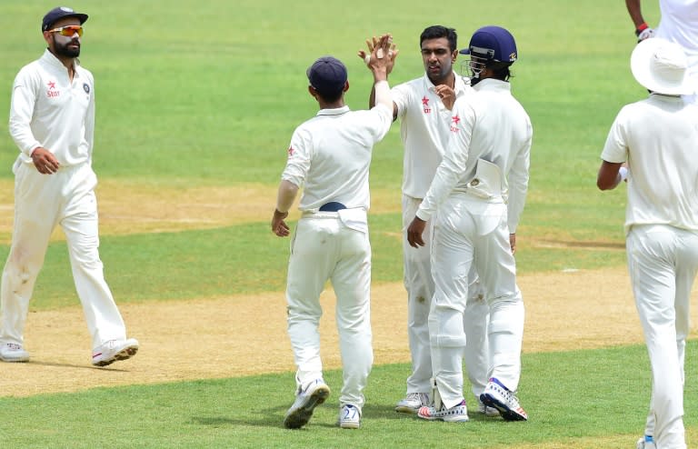 India bowler Ravichandran Ashwin celebrates with teammates after bolwing out Shane Dowrich of the West Indies in the 35th over on July 30, 2016