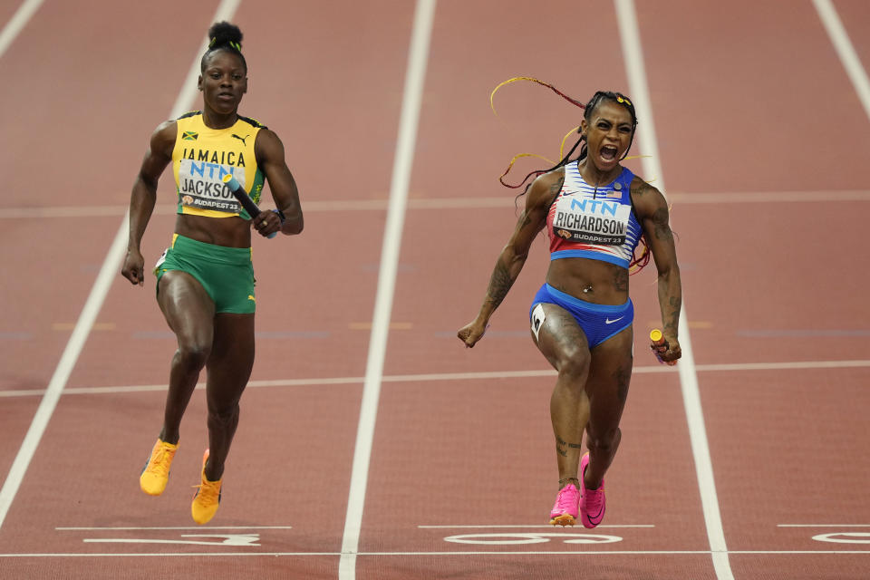 Sha'Carri Richardson, of the United States celebrates anchoring her team to gold ahead of Shericka Jackson, of Jamaica in the Women's 4x100-meters relay final during the World Athletics Championships in Budapest, Hungary, Saturday, Aug. 26, 2023. (AP Photo/Martin Meissner)