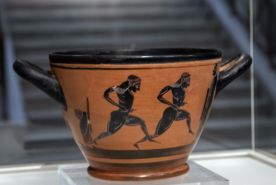 An ancient Greek drinking cup decorated with runners, which was one of the awards presented to Spyros Louis, the Greek winner of the Marathon in the 1896 first modern Olympic Games in Athens, is seen at the National Archaeological Museum in Athens on Wednesday, Nov. 13, 2019. Greece's Culture Ministry said Wednesday the ancient vase has been returned to Athens by the University of Muenster in Germany where it had ended up.(AP Photo/Petros Giannakouris)