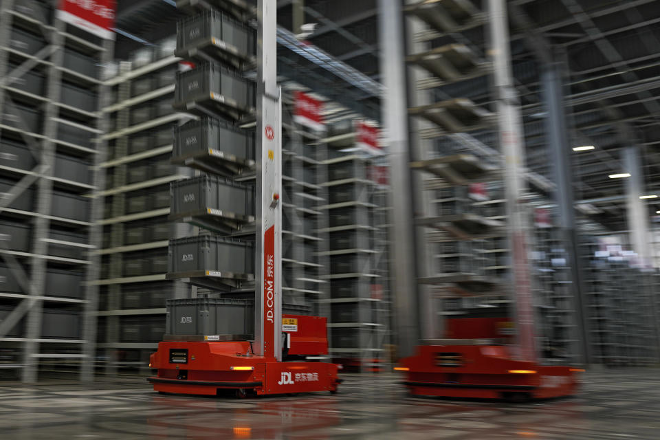 Autonomous robotic machines sort out goods at the Chinese online retailer JD.com's warehouse in Beijing on Tuesday, Nov. 9, 2021. China's biggest online shopping day, known as "Singles' Day" on Nov. 11, is taking on a muted tone this year amid a regulatory crackdown on the technology industry and President Xi Jinping's push for "common prosperity." (AP Photo/Andy Wong)