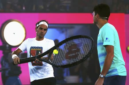 Switzerland's Roger Federer hits a shot with a large racket during a promotional event ahead of the Australian Open tennis tournament in Melbourne, Australia, January 14, 2017. REUTERS/Edgar Su