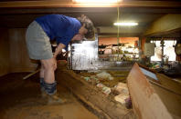 <p>A local resident wipes her tears as she looks at her house buried in earth and sand following heavy flooding in Asakura, Fukuoka prefecture, on July 6, 2017. (Photo: STR/AFP/Getty Images) </p>