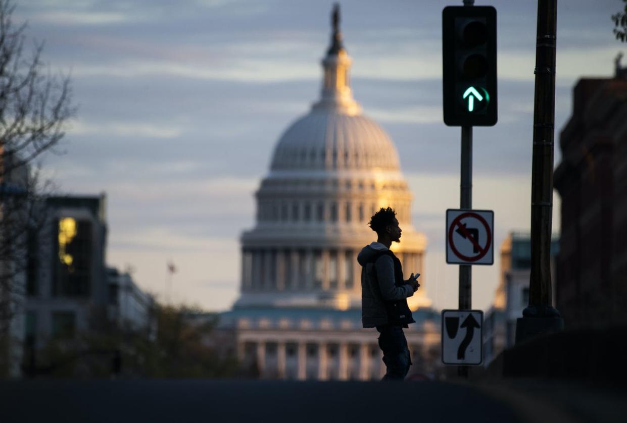 <span class="caption">Laws and policy are being made in Washington -- both inside Congress and out.</span> <span class="attribution"><a class="link " href="https://www.gettyimages.com/detail/news-photo/man-crosses-north-capitol-street-on-m-street-during-the-news-photo/1209502088?adppopup=true" rel="nofollow noopener" target="_blank" data-ylk="slk:Tom Williams/CQ-Roll Call, Inc via Getty Images;elm:context_link;itc:0;sec:content-canvas">Tom Williams/CQ-Roll Call, Inc via Getty Images</a></span>