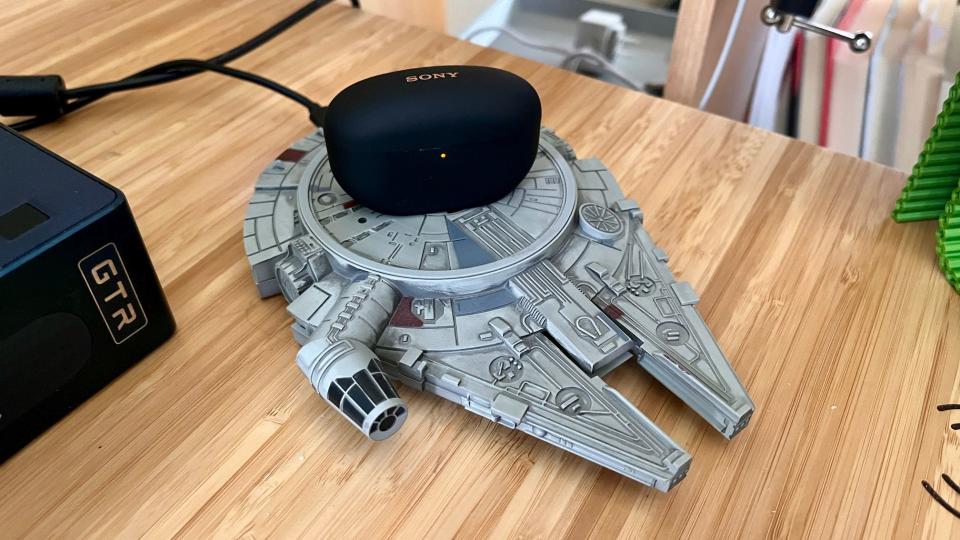 The XM5 case standing on a Qi charging pad designed after the Millennium Falcon.